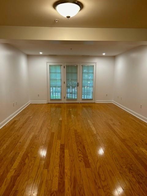 view of the living and dining room, facing the floor to ceiling windows