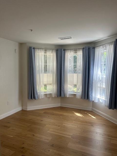 Secondary bedroom with large bay windows and hard flooring