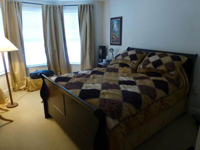 primary bedroom with carpeting and large windows