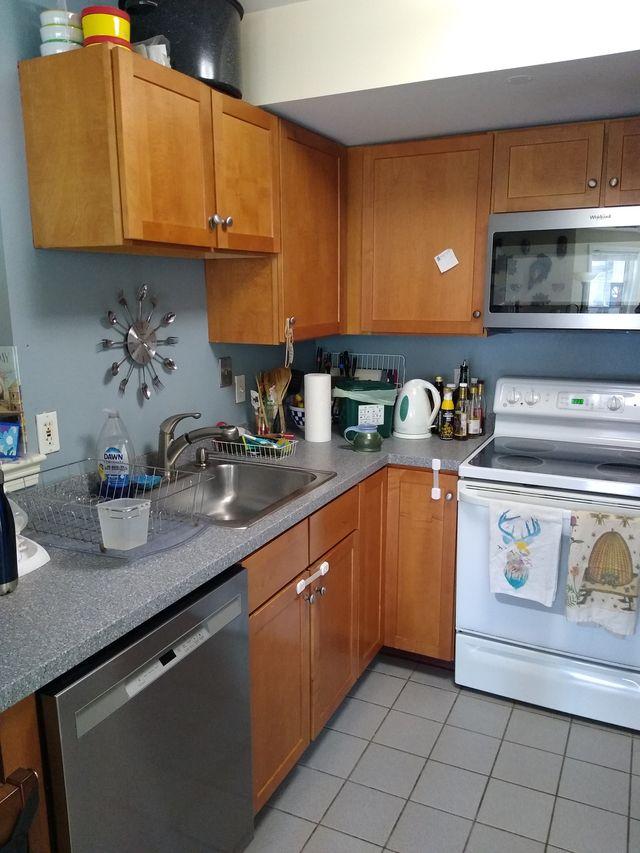 kitchen with tiling and laminate countertops, stainless steel appliances, oak cabinets