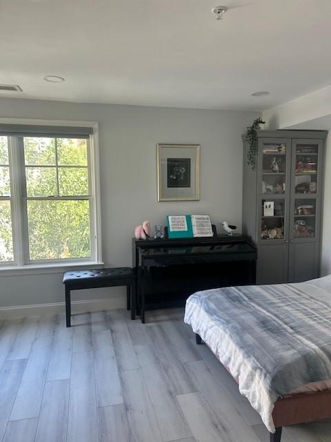 third bedroom with hard flooring and large windows