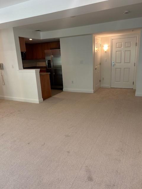 Open concept living and dining room with carpeted flooring