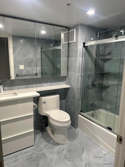 Secondary bathroom with built in vanity and tub/shower combo with sliding glass