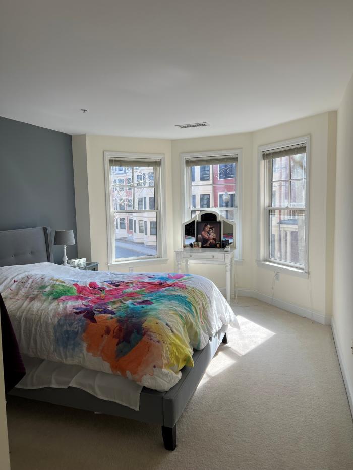 Second bedroom with bay windows and carpet flooring