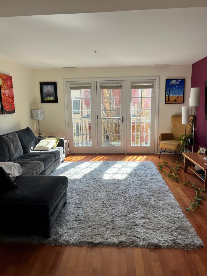combined living and dining area with hard flooring and large bright windows