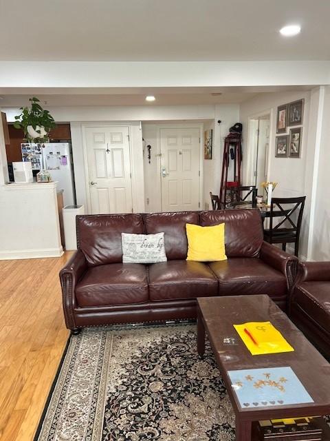 Combined living and dining area with hard flooring and recessed ceiling lighting