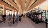 A rendering of the bike storage room, with bike racks and ample sunlight