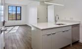 2 bedroom unit with view of living area and kitchen island