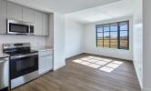 4 bedroom unit with view of living area and kitchen